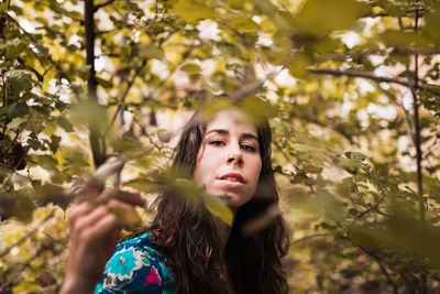 Woman standing on land in forest