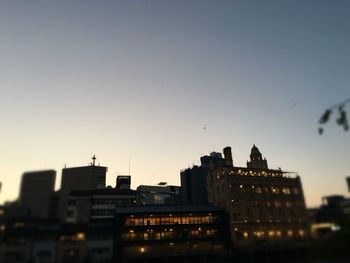 View of illuminated buildings against clear sky