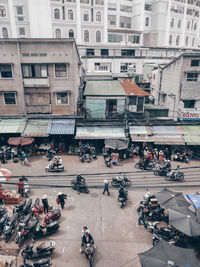 High angle view of people on road against buildings in city