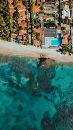 Aerial view of sea against houses in town