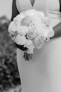 Close-up of woman holding flower bouquet