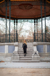 Full length of woman moving down on steps