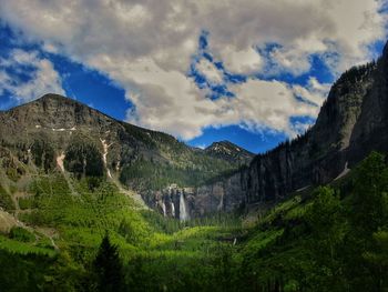 Scenic view of mountains against cloudy sky