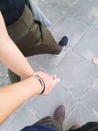 Low section of women standing on footpath