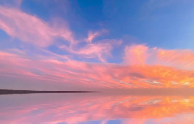 Scenic view of sea against romantic sky at sunset