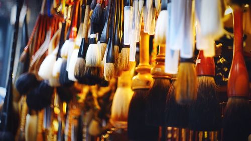 Close-up of brushes hanging for sale