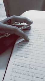 Cropped hand of woman on book