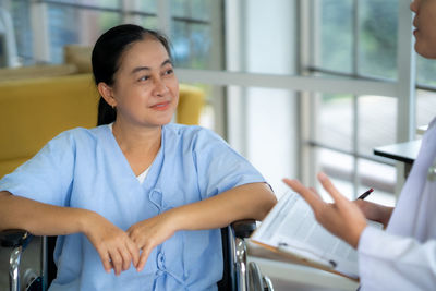 Portrait of young woman sitting in office
