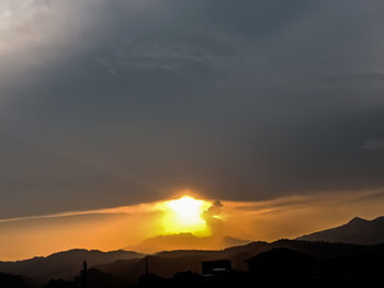 Scenic view of silhouette mountains against sky during sunset