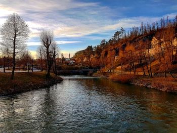 River amidst trees against sky