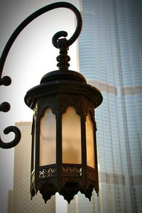 Low angle view of street light against building