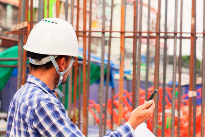 Midsection of man using mobile phone