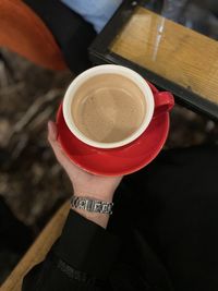 Cropped hand holding coffee