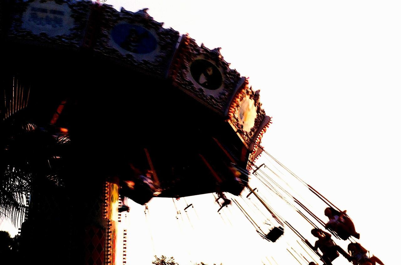 low angle view, clear sky, arts culture and entertainment, sky, built structure, amusement park, architecture, amusement park ride, building exterior, ferris wheel, outdoors, copy space, leisure activity, cultures, day, dusk, tradition, hanging, lantern, no people