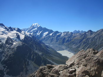 Scenic view of snowcapped mountains against clear blue sky