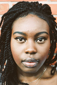 Close-up portrait of young woman with dreadlocks