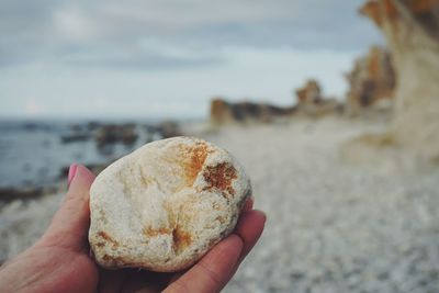 Cropped hand holding rock