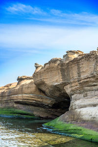 Close-up of rock against blue sky