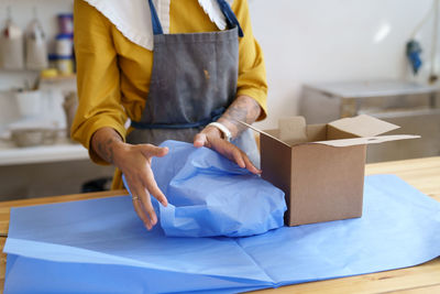 Rear view of man working on box