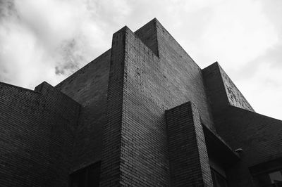 Low angle view of building against cloudy sky