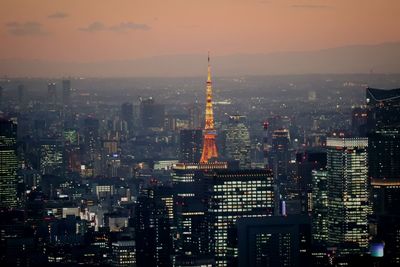 Aerial view of city lit up at sunset