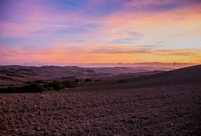 Scenic view of field against sky during sunset
