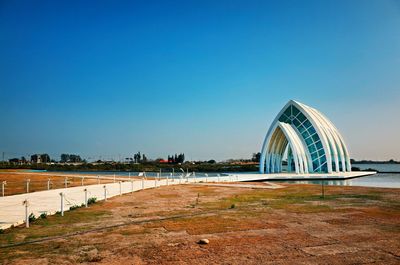 View of arch bridge against clear blue sky