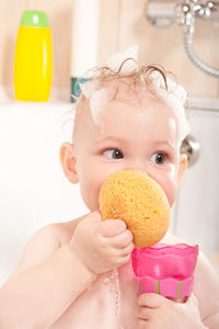 Girl playing with toys in bathtub