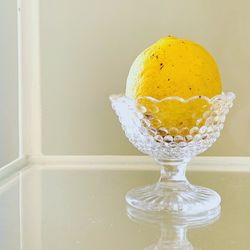 Close-up of lemon in glass bowl on table