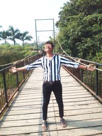 Full length of man standing on footbridge