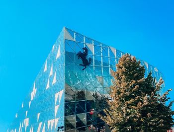 Low angle view of building against clear blue sky