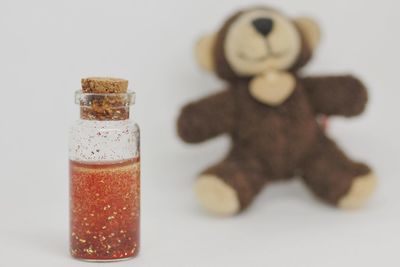 Close-up of jar on table against white background