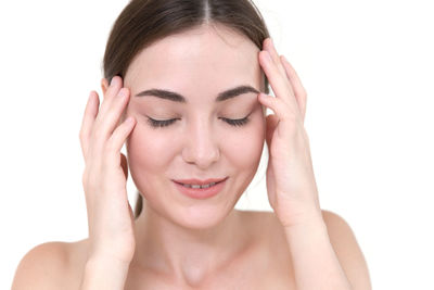 Portrait of a woman with hand against white background