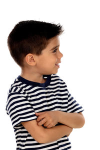 Boy looking away while standing against white background