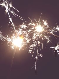 Low angle view of illuminated lights at night