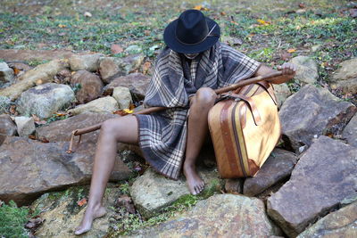 High angle view of man sitting on rock