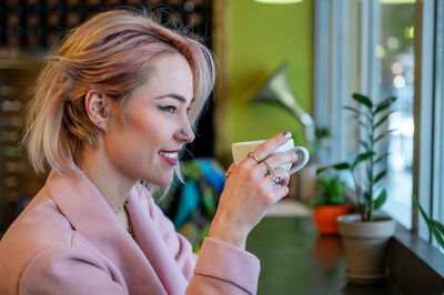 Close-up of young woman drinking glass