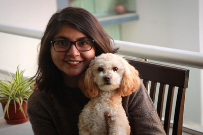 Portrait of woman with dog at home