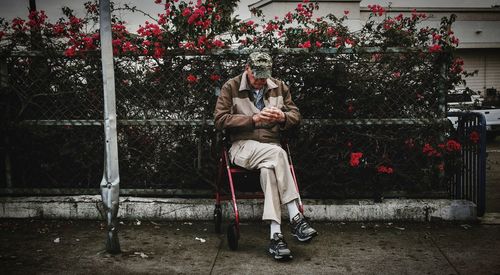 Young men sitting on tree