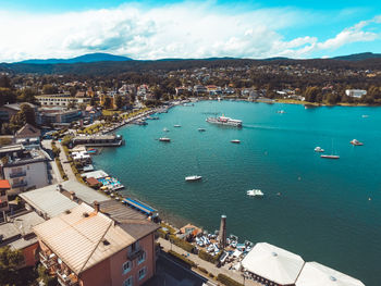 High angle view of city by sea against sky