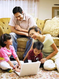 Family using laptop at home