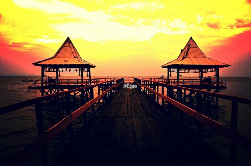 sea, water, sunset, horizon over water, sky, beach, scenics, tranquility, pier, tranquil scene, orange color, beauty in nature, idyllic, the way forward, nature, gazebo, cloud - sky, built structure, shore, dusk
