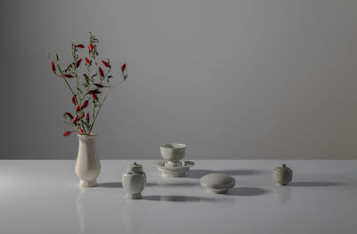 Close-up of vase on table against white background