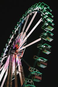 Low angle view of ferris wheel at night