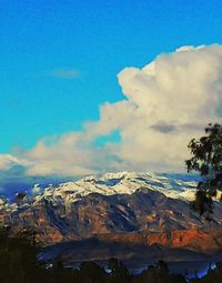 Scenic view of mountains against blue sky
