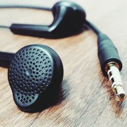 Macro shot of headphones on wooden table