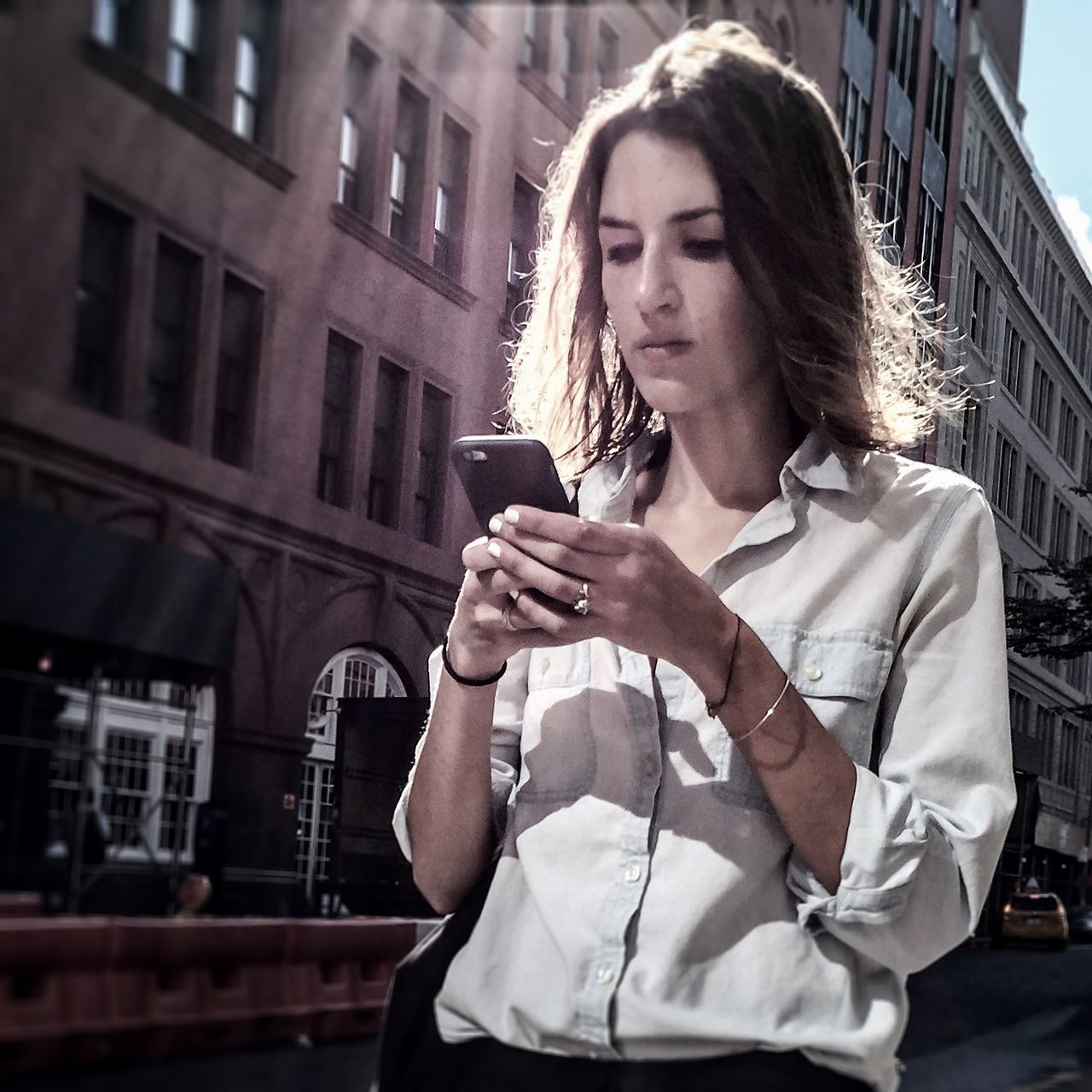 young adult, person, lifestyles, casual clothing, building exterior, front view, young women, built structure, architecture, leisure activity, three quarter length, standing, smiling, looking at camera, portrait, focus on foreground, holding