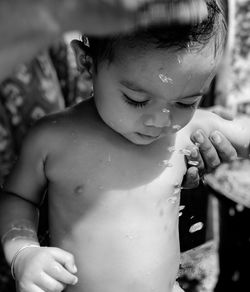 Woman bathing baby boy