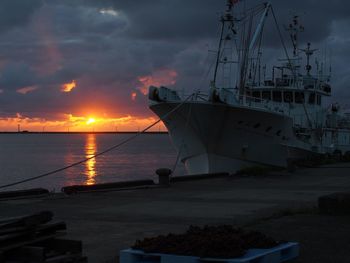 Sailboat in sea at sunset