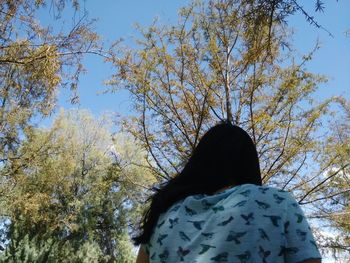 Low angle view of woman against clear sky